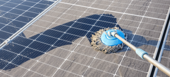 Scrubbing dust off solar panels at a solar farm