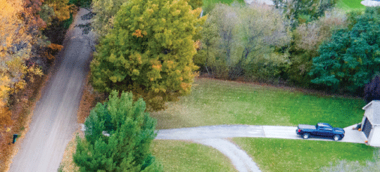 Aerial photo of a home along an unpaved county road in Michigan